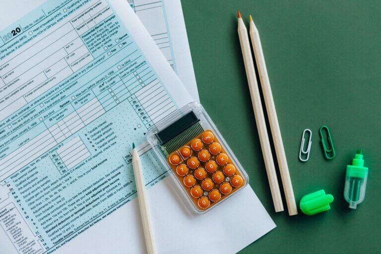 documents and calculator with pens, registering for IPT