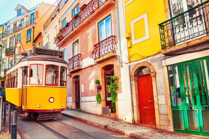 Tram in Lisbon in front of colorful houses