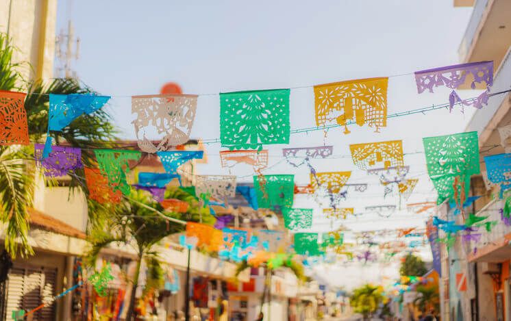 Colorful papers between houses in Mexico