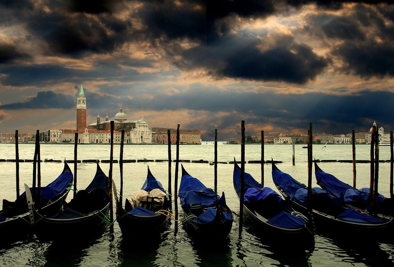 Gondolas moored at the pier in Grand Canal with San Giorgio Maggiore in the background, Venice, Italy