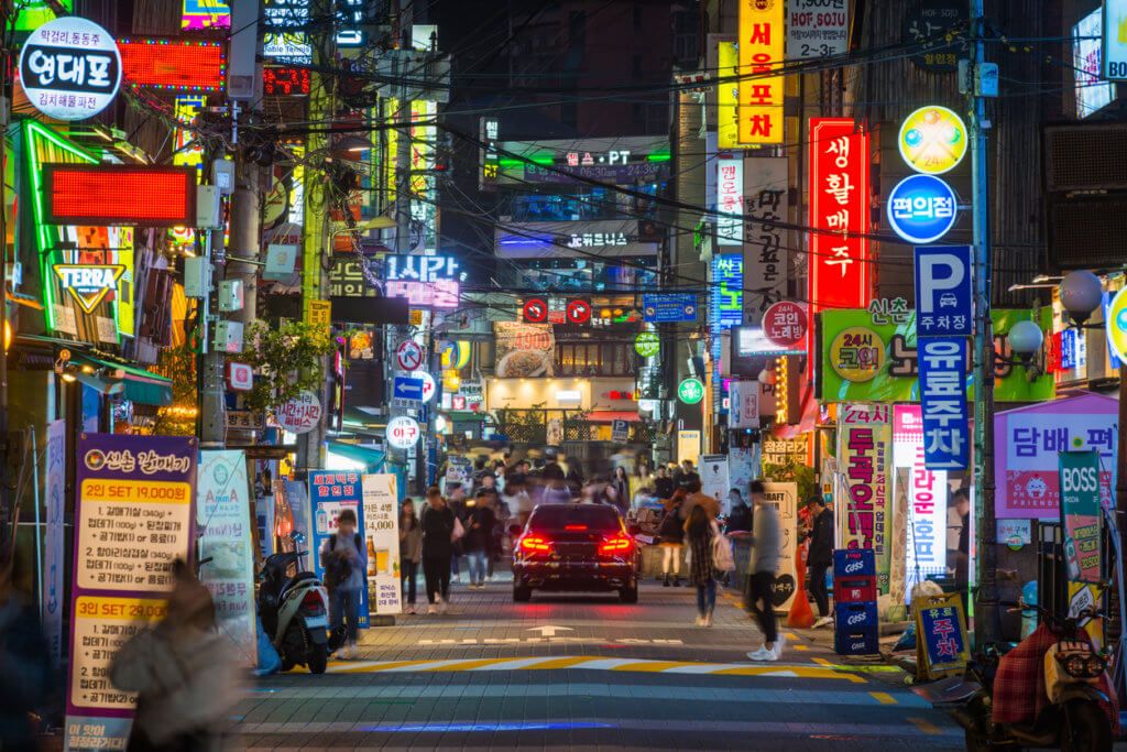 Seoul crowded streets of Sinchon nightlife neon signs South Korea