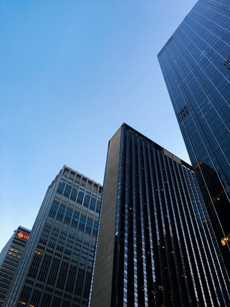 Four buildings in New York City seen from below.