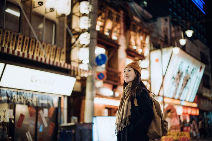 Female Asian traveler exploring nightlive in Okinawa, Japan