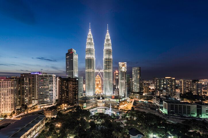 Malaysia, Kuala Lumpur, the Petronas Towers at dusk, elevated view.