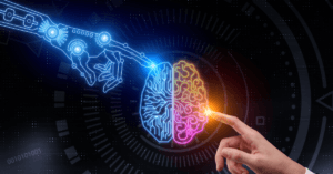 A robotic hand and a human finger touch a stylized brain graphic, representing artificial intelligence and human intelligence connection.